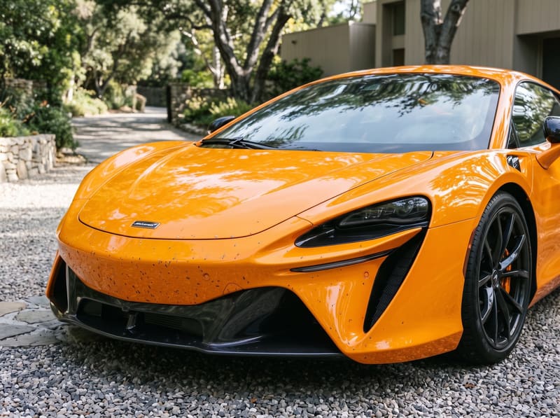 Paint protection film in Los Angeles: the nose of a papaya orange McLaren Artura with bug splatter and tar specks